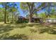 Spacious property featuring a log cabin home with an expansive yard and mature trees at 14114 N 301 Hwy, Thonotosassa, FL 33592