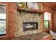 Close-up of the stone fireplace with a decorative mantel and hearth at 14114 N 301 Hwy, Thonotosassa, FL 33592