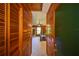 Hallway view into a bedroom, highlighting wood-paneled walls and a glimpse of the interior at 14114 N 301 Hwy, Thonotosassa, FL 33592