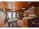 Spacious kitchen featuring wood cabinets, stainless steel appliances, and breakfast bar seating at 14114 N 301 Hwy, Thonotosassa, FL 33592