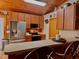 The kitchen features wood cabinets, stainless appliances, and a breakfast bar with seating at 14114 N 301 Hwy, Thonotosassa, FL 33592