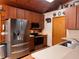 The kitchen features wood cabinetry, stainless steel appliances, and a stainless steel sink at 14114 N 301 Hwy, Thonotosassa, FL 33592