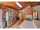 Rustic kitchen featuring stainless steel appliances, wood cabinets, and a skylight at 14114 N 301 Hwy, Thonotosassa, FL 33592