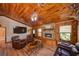 Warm living room with wood accents, stone fireplace, and a comfortable seating area at 14114 N 301 Hwy, Thonotosassa, FL 33592