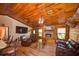 Cozy living room with wood paneling, a stone fireplace, and comfortable seating at 14114 N 301 Hwy, Thonotosassa, FL 33592