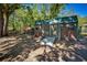 Exterior of a shed with double doors, a green corrugated roof, and green trim with a chicken coop at 14114 N 301 Hwy, Thonotosassa, FL 33592