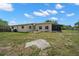 The back of the home includes a large backyard and an enclosed patio at 1542 Picardy Cir, Clearwater, FL 33755
