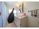 Bathroom featuring a single sink vanity, mirror, and a combination shower and tub at 1542 Picardy Cir, Clearwater, FL 33755