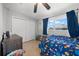 bedroom with blue accents, tiled floors, and closet space for storage at 1542 Picardy Cir, Clearwater, FL 33755