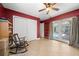 Bonus room featuring a closet, tiled floors, a rocking chair, and doors to a beautiful pool area at 1542 Picardy Cir, Clearwater, FL 33755