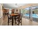 Open dining area with tile floors and views of the inviting screened-in pool at 1542 Picardy Cir, Clearwater, FL 33755