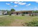 Charming single-story home with a well-maintained lawn and welcoming front entrance at 1542 Picardy Cir, Clearwater, FL 33755