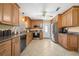 Well-lit kitchen featuring granite countertops, stainless steel appliances, and wood cabinets at 1542 Picardy Cir, Clearwater, FL 33755