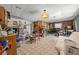 Spacious living room featuring tile flooring, brick accent wall, and ample natural light at 1542 Picardy Cir, Clearwater, FL 33755