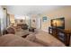 Cozy living room featuring neutral walls, tile flooring, and comfortable seating at 1542 Picardy Cir, Clearwater, FL 33755