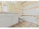 Bathroom featuring patterned tile floor, white vanity, toilet, shower and bath combination with decorative tile accents at 17108 Carrington Park Dr # 711, Tampa, FL 33647