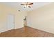 Spacious bedroom with hardwood floors, ceiling fan, and plenty of natural light with a view of backyard at 17108 Carrington Park Dr # 711, Tampa, FL 33647