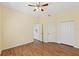 This bedroom has a ceiling fan, wood floors, and two closets at 17108 Carrington Park Dr # 711, Tampa, FL 33647