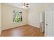 Bright bedroom with wood floors, a large window, and access to another room at 17108 Carrington Park Dr # 711, Tampa, FL 33647