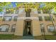 Exterior view of a beige two-story apartment building with stairs leading up to the units at 17108 Carrington Park Dr # 711, Tampa, FL 33647