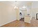 Open dining area near the kitchen features hardwood floors and a modern chandelier lighting fixture at 17108 Carrington Park Dr # 711, Tampa, FL 33647