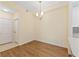 Charming dining area with modern light fixture, tile entry and hardwood flooring for a cozy atmosphere at 17108 Carrington Park Dr # 711, Tampa, FL 33647