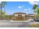 Community clubhouse boasts an inviting entrance, manicured landscaping, and ample parking for residents and guests at 17108 Carrington Park Dr # 711, Tampa, FL 33647