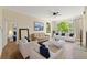 Inviting living room featuring modern furniture, hardwood floors, and large windows with natural light at 17108 Carrington Park Dr # 711, Tampa, FL 33647
