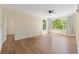 Bright living room featuring hardwood floors, large windows, and ceiling fan at 17108 Carrington Park Dr # 711, Tampa, FL 33647