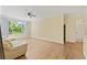 Bright living room featuring hardwood floors, a ceiling fan, and a large window with natural light at 17108 Carrington Park Dr # 711, Tampa, FL 33647