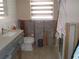 Bathroom with updated vanity, toilet, and partial block wall and visible studs around the shower at 1844 Venetian Point Dr, Clearwater, FL 33755