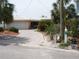 Charming single-Gathering home with a driveway, and lush landscaping, providing a welcoming curb appeal at 1844 Venetian Point Dr, Clearwater, FL 33755