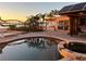 Pool and water view at sunset with solar panels, tropical landscaping, and a relaxing outdoor space at 1844 Venetian Point Dr, Clearwater, FL 33755