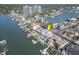 Aerial view highlighting a waterfront property with a boat dock, swimming pool, and luxurious canal-front living at 2829 Seabreeze S Dr, Gulfport, FL 33707