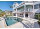 Multi-level backyard with pool, patio, spiral staircase, and lush tropical landscaping at 2829 Seabreeze S Dr, Gulfport, FL 33707