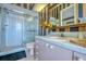 The bathroom features pink cabinets, striped wallpaper, and a glass-enclosed shower at 2829 Seabreeze S Dr, Gulfport, FL 33707