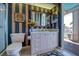 A bathroom with striped wallpaper features a pink vanity and access to the outdoors at 2829 Seabreeze S Dr, Gulfport, FL 33707
