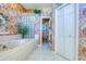 Bathroom showcasing a large tub with jets and a walk-in closet offering ultimate relaxation and convenience at 2829 Seabreeze S Dr, Gulfport, FL 33707
