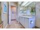 Well lit bathroom featuring a modern vanity and tiled floors, offering a clean and functional space at 2829 Seabreeze S Dr, Gulfport, FL 33707