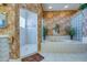 Spacious bathroom featuring tub, walk-in shower, and decorative tiling, offering a luxurious experience at 2829 Seabreeze S Dr, Gulfport, FL 33707