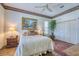 Bright bedroom with queen bed, floral wallpaper, and spacious closet at 2829 Seabreeze S Dr, Gulfport, FL 33707