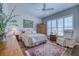 Bedroom with neutral tones features a queen bed, sitting chair, and bright windows at 2829 Seabreeze S Dr, Gulfport, FL 33707