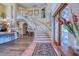 Spacious foyer features a winding staircase, high ceilings, and elegant decor at 2829 Seabreeze S Dr, Gulfport, FL 33707