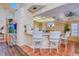Eat-in kitchen features bar seating, warm neutral countertops and backsplash, and an adjacent built-in fish tank at 2829 Seabreeze S Dr, Gulfport, FL 33707