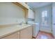 Functional laundry room with ample counter space and storage cabinets at 2829 Seabreeze S Dr, Gulfport, FL 33707
