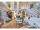 Spacious living room with fireplace, winding staircase, and comfortable seating at 2829 Seabreeze S Dr, Gulfport, FL 33707