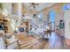 Bright living room with soaring ceilings, large windows, fireplace, and winding staircase at 2829 Seabreeze S Dr, Gulfport, FL 33707