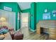 A cozy living room with a leather chair, wooden desk, and bright green walls and trim at 2829 Seabreeze S Dr, Gulfport, FL 33707