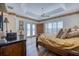 This main bedroom has a tray ceiling, plantation shutters, wood floors and access to the balcony at 2829 Seabreeze S Dr, Gulfport, FL 33707