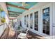 Inviting patio with a teal ceiling, perfect for outdoor dining and relaxation at 2829 Seabreeze S Dr, Gulfport, FL 33707
